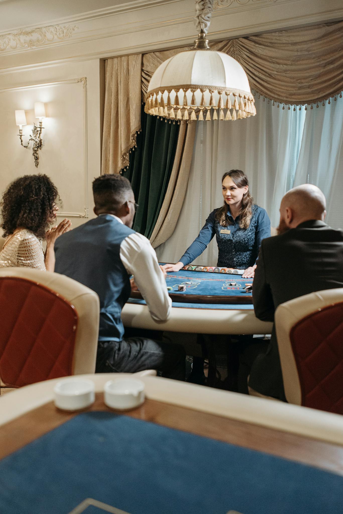 A group of adults engaged in a lively card game at a stylish casino table.